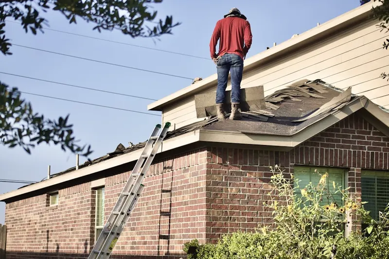 Professional roofer working on a residential roof in Ordmont